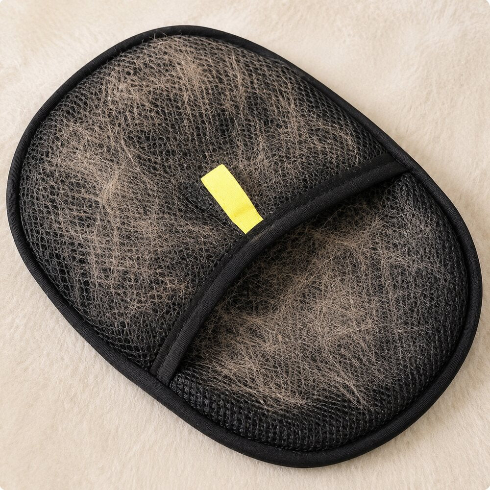 Pet fur collected on the reusable grooming glove