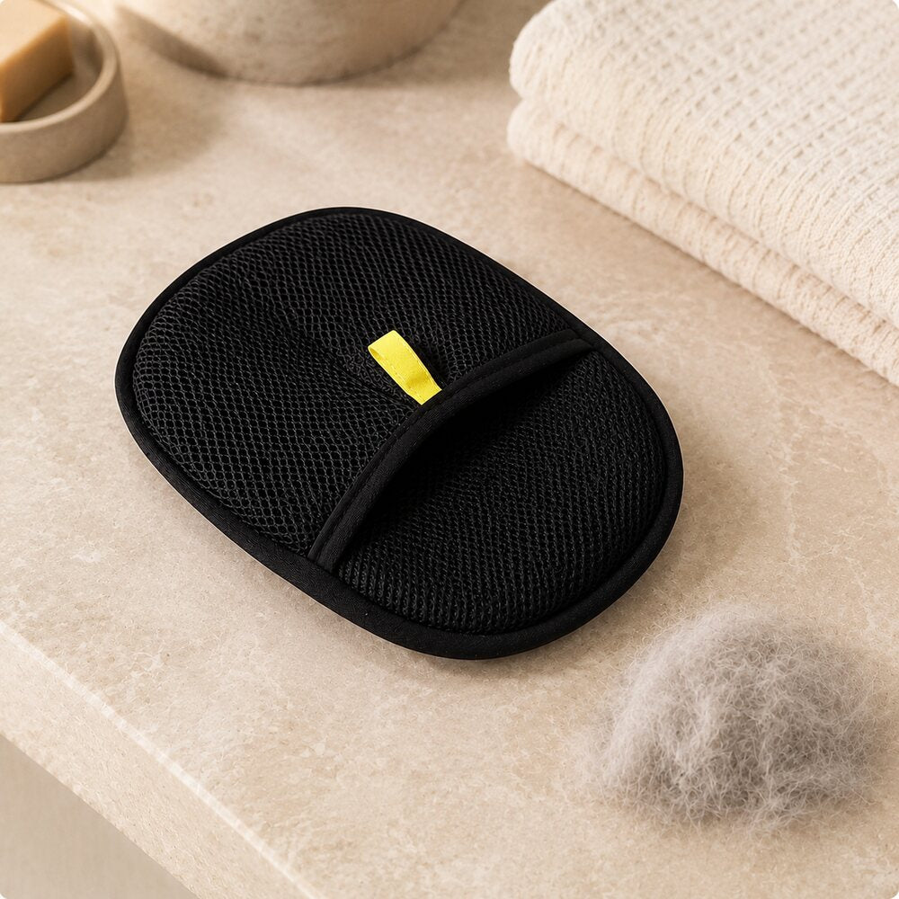 Reusable grooming glove beside removed pet fur